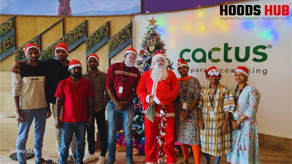 Hoods Hub team celebrates with a team Christmas party photo. Happy coworkers in festive attire enjoy a group photo with Santa